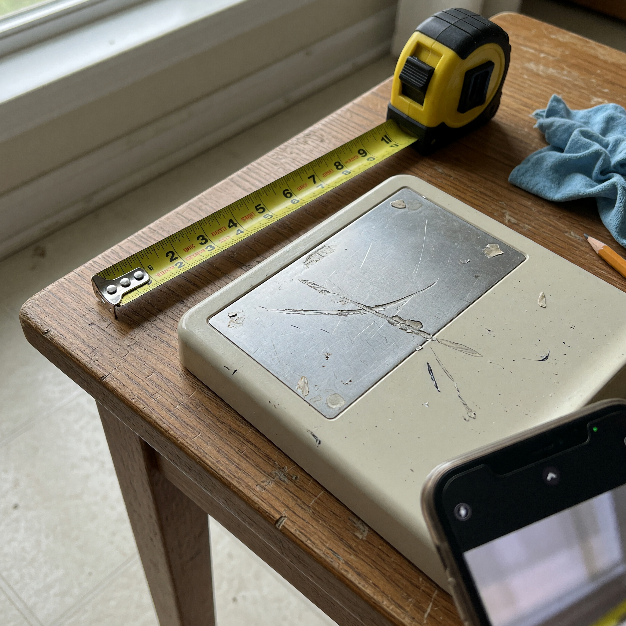 Used item prepared with measuring tape and visible condition details for a local listing