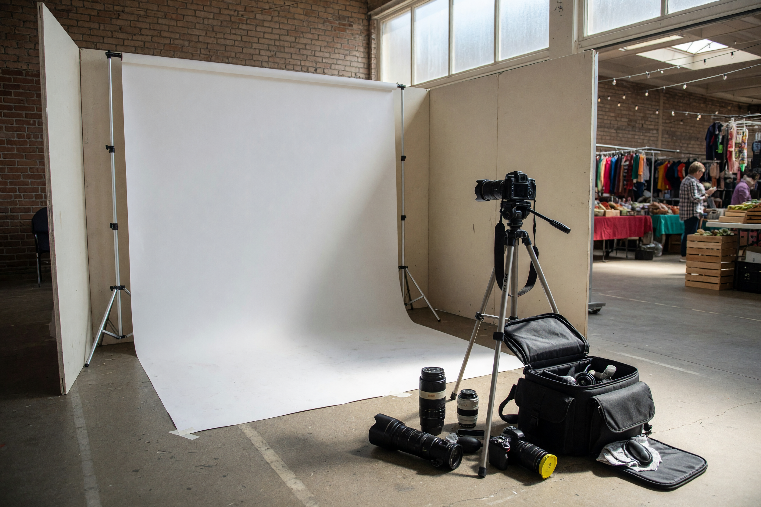 Camera and plain backdrop set up for an event photography service listing