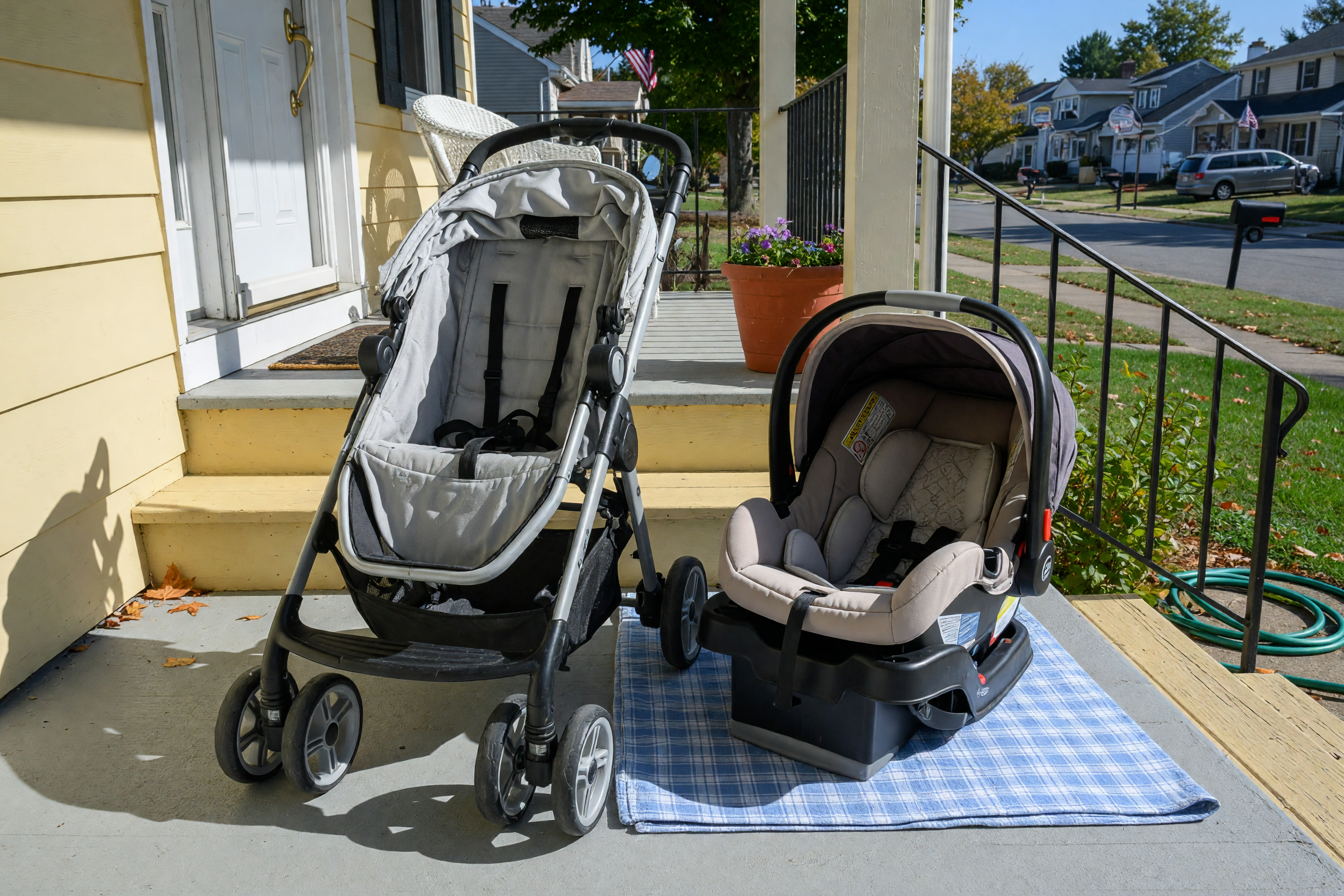 Clean used stroller and infant car seat with base arranged on a front porch for local pickup