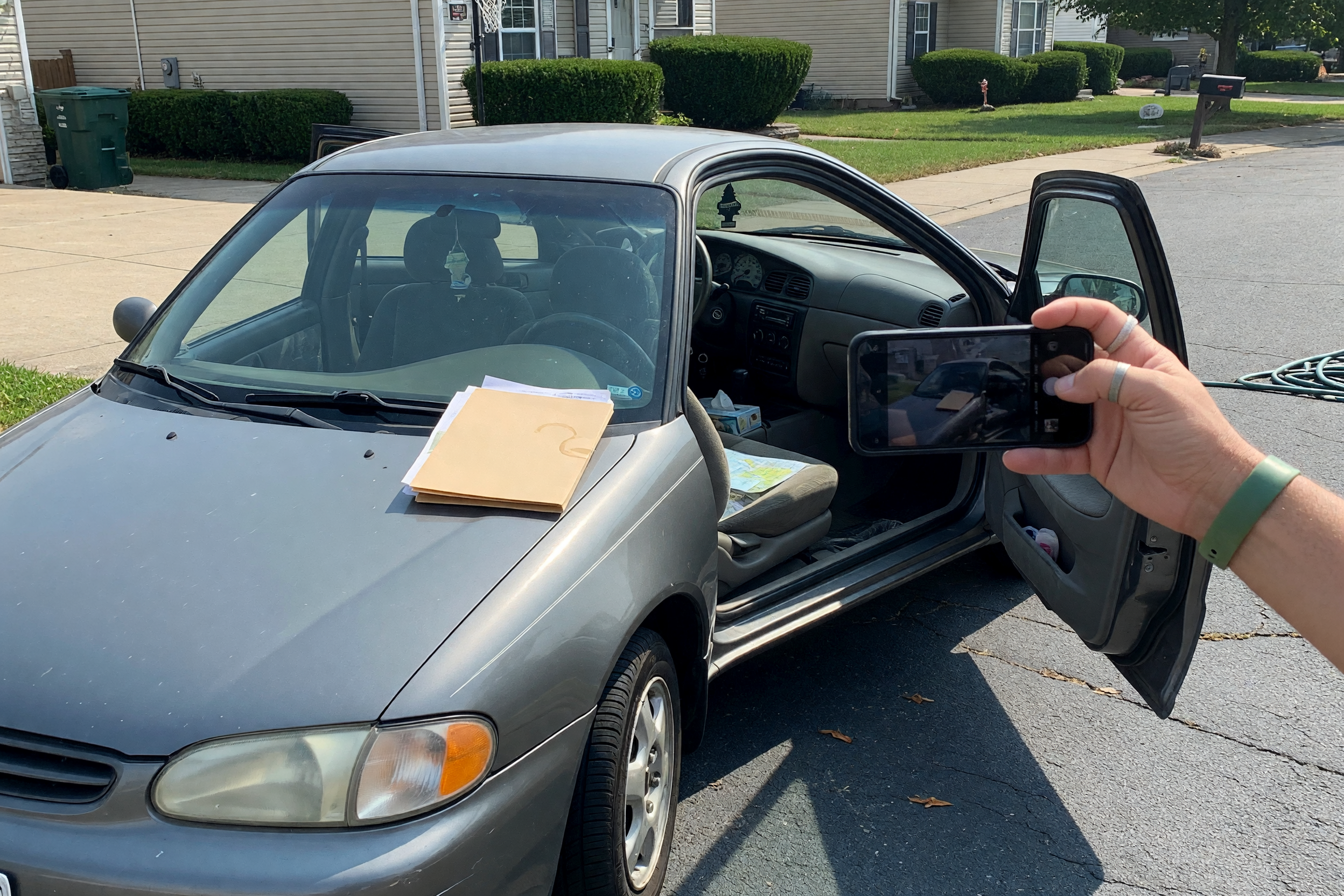 Private seller photographing an unbranded used sedan for a local car listing